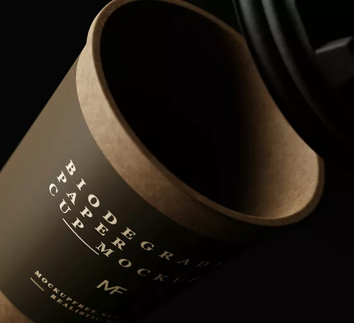 Biodegradable paper cup mockup with elegant typography on kraft material, shown with black lid and coffee beans on dark surface